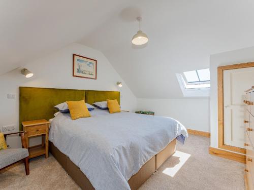 a bedroom with a large bed with yellow pillows at 4 Bed in Church Stretton 87695 in Cardington