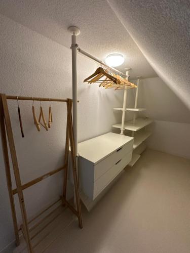 a attic room with a closet with hangers at Apartmenthouse Singen in Singen