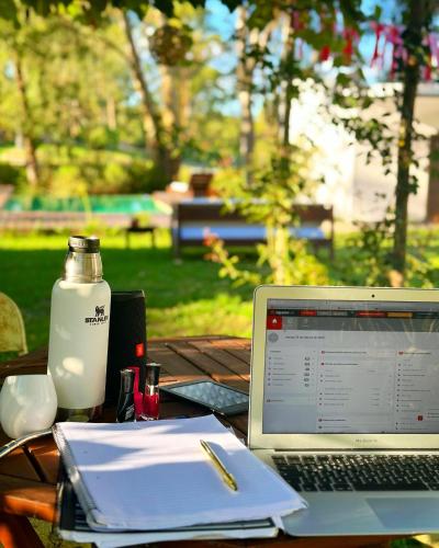 a laptop computer sitting on a table with a bottle of milk at Al Natural Posada in Nueva Palmira