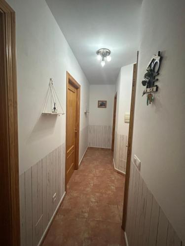 a hallway with a hallway leading into a room with a door at Casa Alegría in Cómpeta