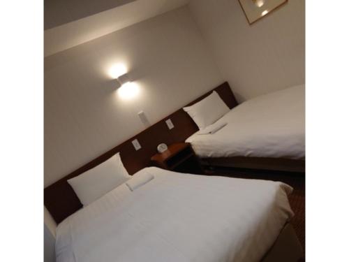 a hotel room with two beds in a room at Smile Hotel Namba - Vacation STAY 37197v in Osaka