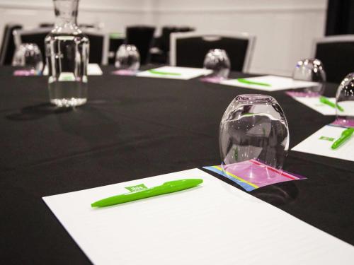 a green pen sitting on top of a black table at ibis Styles Mt Isa Verona in Mount Isa