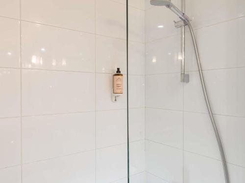 a shower with a glass door with a soap bottle at Mercure Paris CDG Airport & Convention in Roissy-en-France