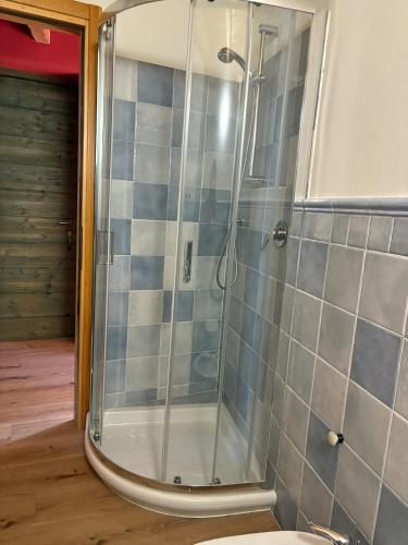 a shower with a glass door in a bathroom at Casa Sofia Panoramic View and Private Box in Temù