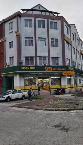 a large building with a car parked in front of it at Anjung Seri Condo next Permas Jaya, Regency Hospital, jb ciq 15km in Masai