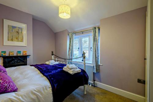 a bedroom with a bed and a window at Warborough House East in Kelling