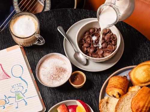 a table with a bowl of food and a cup of coffee at ibis Montpellier Centre Comedie in Montpellier