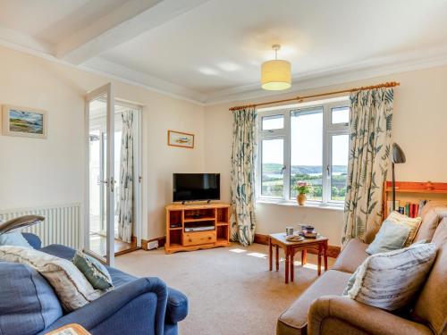 a living room with two couches and a tv at 2 bed property in Thurlestone WDELV in Thurlestone