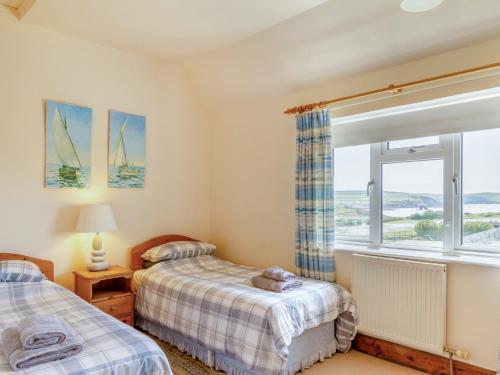 a bedroom with two beds and a window at 2 bed property in Thurlestone WDELV in Thurlestone