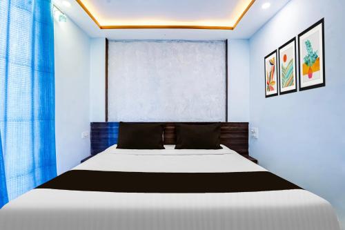 a bedroom with a white bed and a window at FabHotel Arambol Inn in Arambol