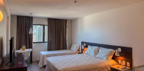 Ένα ή περισσότερα κρεβάτια σε δωμάτιο στο Ritz Suítes 215 Beira-Mar - Hosti