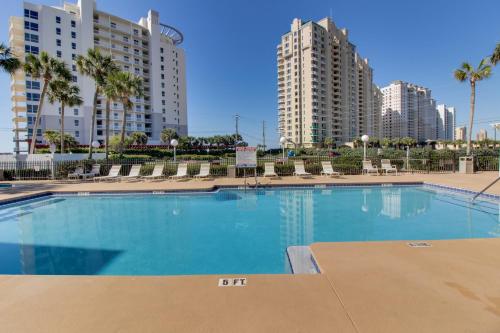 a large swimming pool with buildings in the background at Grand Caribbean East & West W204 in Perdido Key