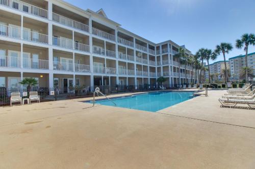 a large apartment building with a swimming pool and palm trees at Grand Caribbean East & West W204 in Perdido Key