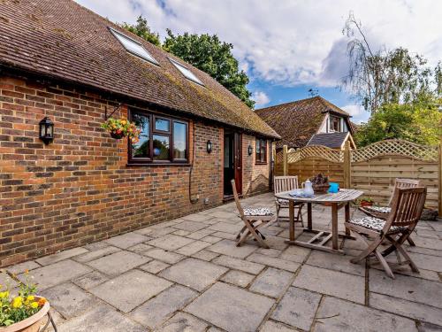 a patio with a table and chairs in front of a house at 2 Bed in Hailsham 89416 in Hailsham