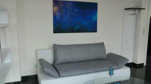 a living room with a couch and a glass table at Hotel Jungstil in Darmstadt