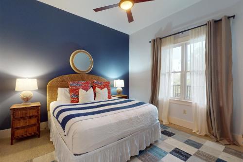 a bedroom with a bed with a mirror on the wall at Redfish Village M1-220 in Blue Mountain Beach