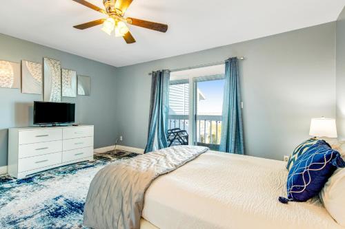 a bedroom with a bed and a ceiling fan at Sandcastle #18 in Navarre