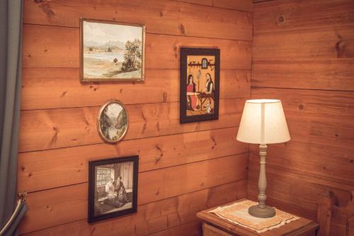 a room with wood paneled walls with pictures and a lamp at Bergidyll Heiligenblut am Glockner in Heiligenblut