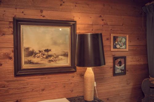 a lamp in a room with a painting on the wall at Bergidyll Heiligenblut am Glockner in Heiligenblut