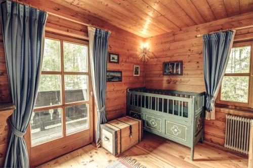 a room with a bed in a log cabin at Bergidyll Heiligenblut am Glockner in Heiligenblut