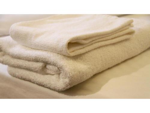 a pile of white towels sitting on top of a counter at Smile Hotel Tokyo Shinkoiwa - Vacation STAY 33631v in Tokyo