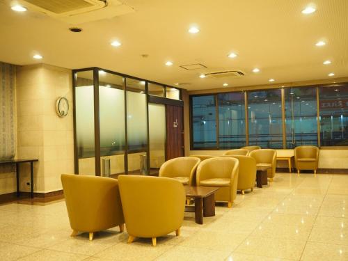 a waiting room with chairs and tables and a clock at Smile Hotel Tokyo Shinkoiwa - Vacation STAY 33628v in Tokyo