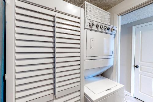 a kitchen with a refrigerator and a stove at Silver Beach 704 in Romar Beach