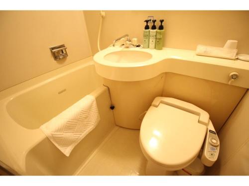 a small bathroom with a toilet and a sink at Smile Hotel Tokyo Shinkoiwa - Vacation STAY 82160v in Tokyo