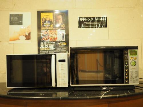 a microwave sitting on top of a counter at Smile Hotel Tokyo Shinkoiwa - Vacation STAY 82160v in Tokyo