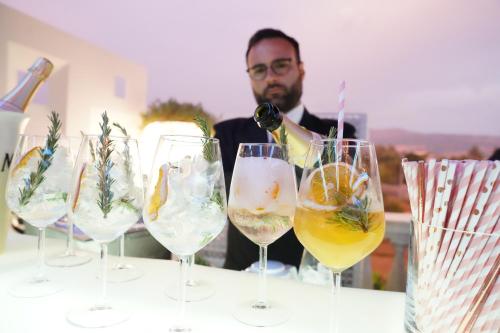 a man pouring wine into wine glasses on a table at Villa Caribe Resort & Spa in Spigno Saturnia