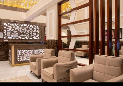 a lobby with chairs and a fireplace in a building at شقق فينا in Khamis Mushayt