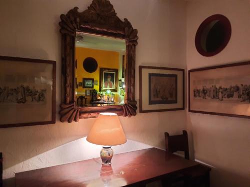 a lamp on a table in a room with a mirror at Hacienda Santa Clara, Morelos, Tenango, Jantetelco in Jantetelco