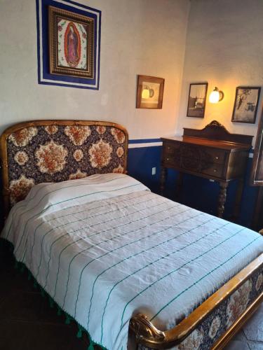 a bedroom with a bed and a dresser and a piano at Hacienda Santa Clara, Morelos, Tenango, Jantetelco in Jantetelco