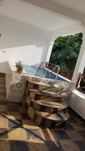 een houten trap in een kamer met een raam bij Silvio family house in Frere Town