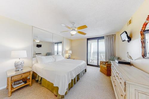 a bedroom with a large bed and a window at Wind Drift 512S in Perdido Key