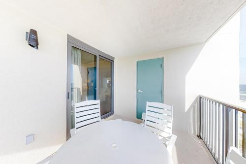 a white dining room with a white table and chairs at Wind Drift 512S in Perdido Key