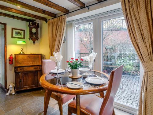 a dining room with a table and a window at 1 Bed in Fenny Bentley 80376 in Fenny Bentley