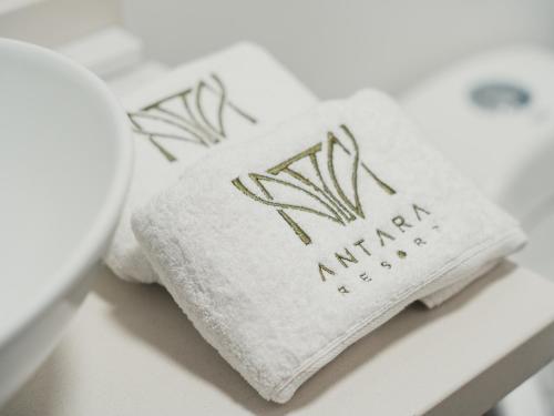 a white towel with the words nirvana on it at Antara Resort in Alcalá