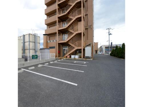 an empty parking lot in front of a building at Smile Hotel Sakurambo Higashine - Vacation STAY 30008v in Higashine