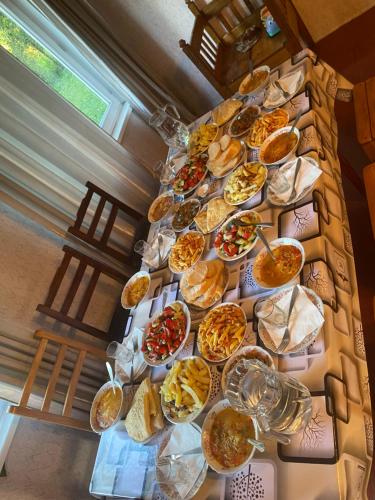 a table topped with lots of different types of food at Zuriko Kakhiani's Guest House in Zhabeshi