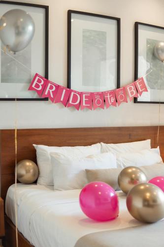 a bed with balloons and a birthday sign on it at The Strabon Tulum in Tulum