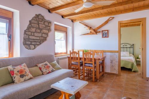 a living room with a couch and a table at Casa Maza Apartamentos in Biescas