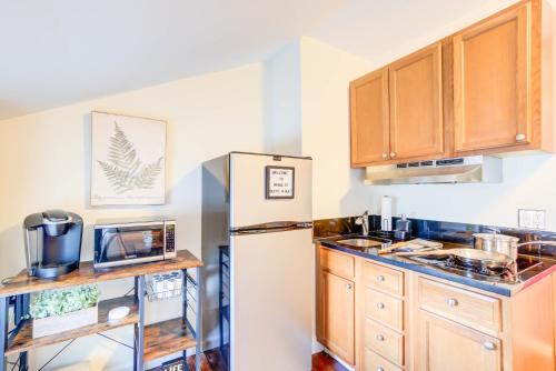 a kitchen with wooden cabinets and a refrigerator at Historic OLD TOWN Block 2 KING ST 99 Walkscore in Alexandria