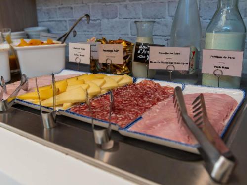 a buffet with meats and cheese and other foods at ibis Lyon Est Bron in Bron