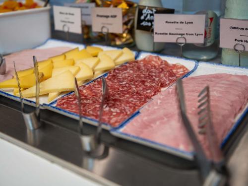 a display of cheese and meats on a counter at ibis Lyon Est Bron in Bron