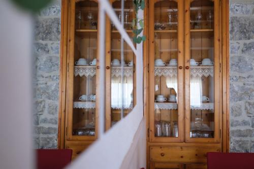 a wooden display cabinet with china in it at Casa Maza Apartamentos in Biescas