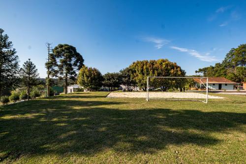 a soccer field with a goal in the grass at Chácara Cabanas e Eventos Peniel in Campina Grande do Sul