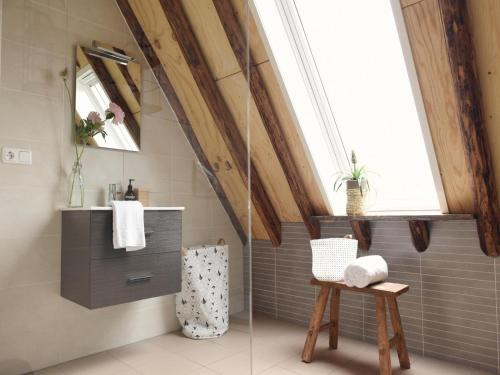 a bathroom with a glass shower in a attic at Apartment with Garden in Dutch Countryside in Callantsoog
