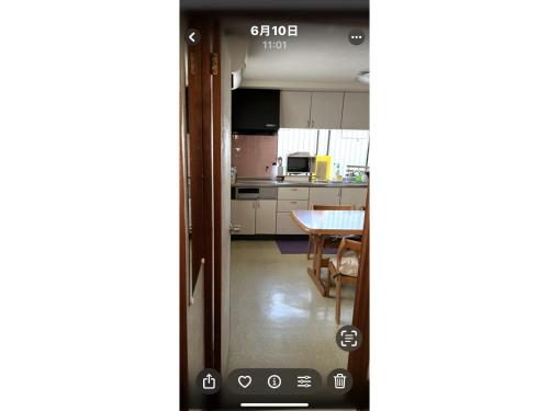 an open door to a kitchen with a table at Guest House Aoi - Vacation STAY 19905 in Mitsugarasuchō