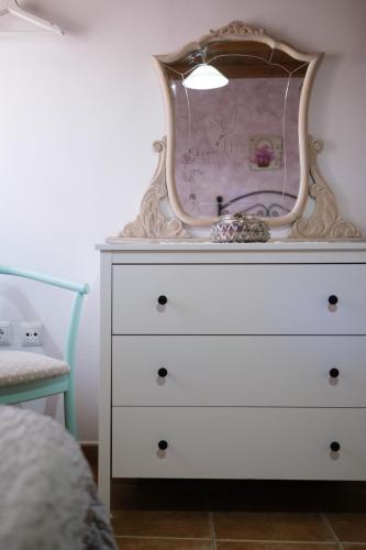 a dresser with a mirror on top of it at Casa Maza Apartamentos in Biescas